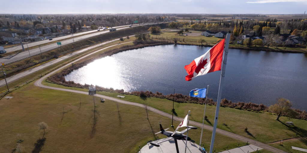 The Canadian & Albertan flags fly over the Leduc reservoir.