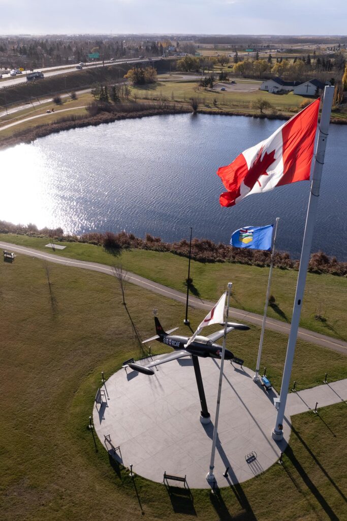 The Canadian & Albertan flags fly over the Leduc reservoir.