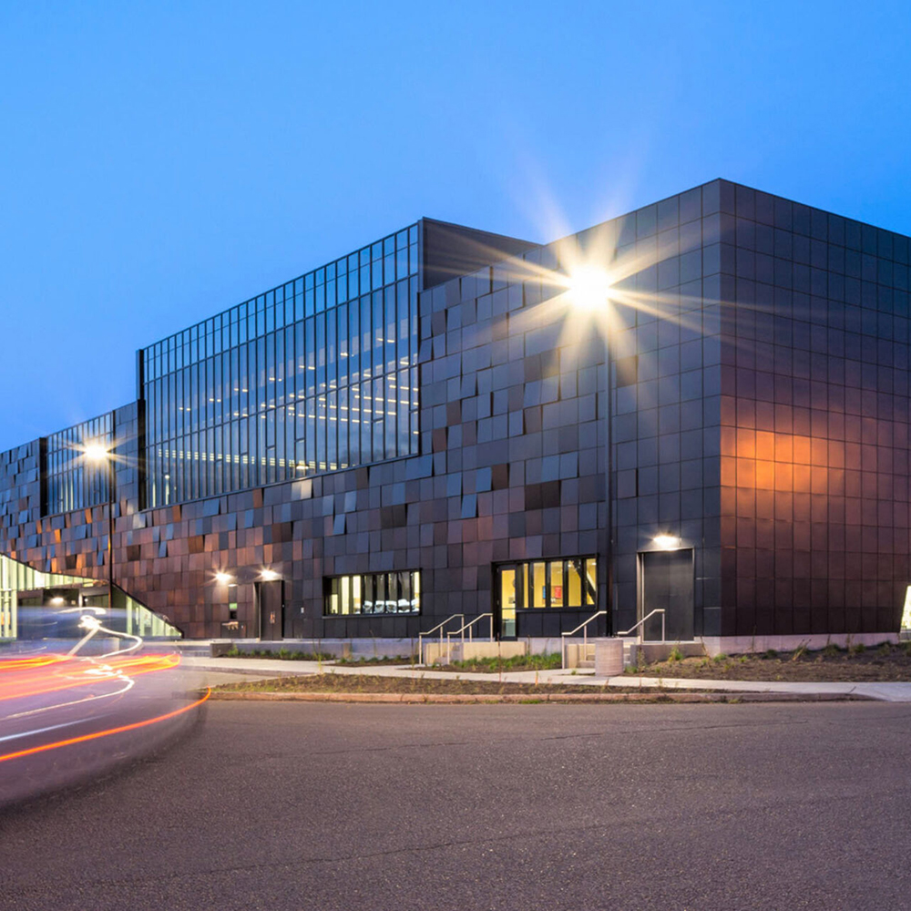 The Mill Woods library at night; a time-delay photo with traffic lights swirling along the road.