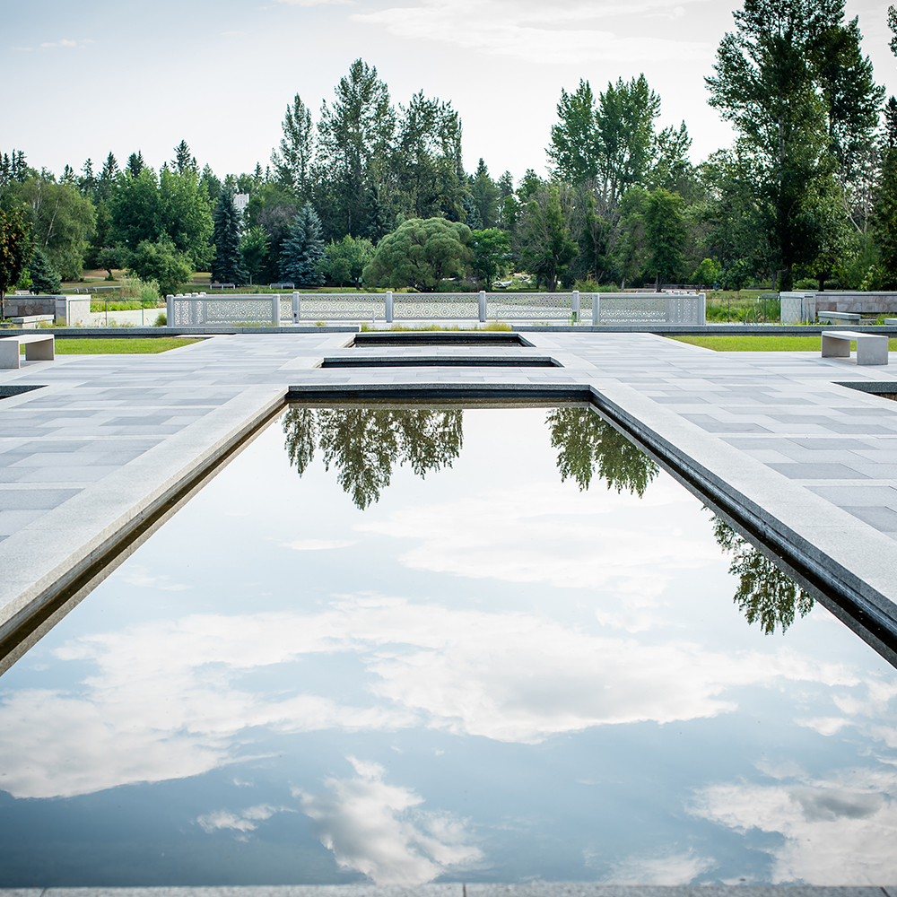 Tree and cloud reflection in a water feature at the new Aga Khan Garden, Devon Botanical Gardens.