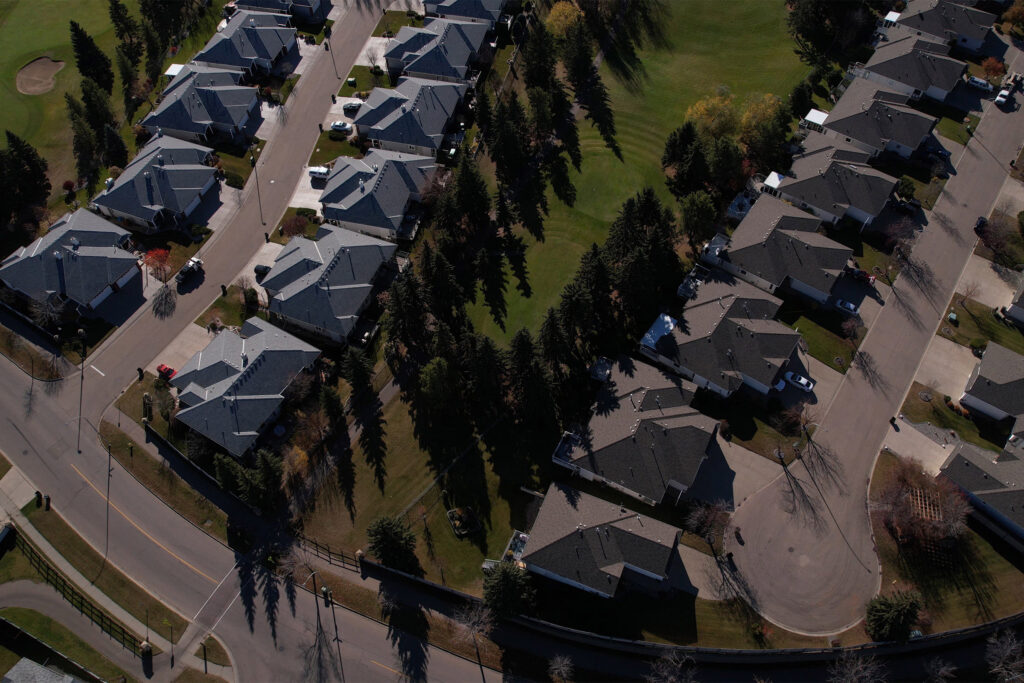 A drone shot of the Spruce Grove golf course, with large homes near by.