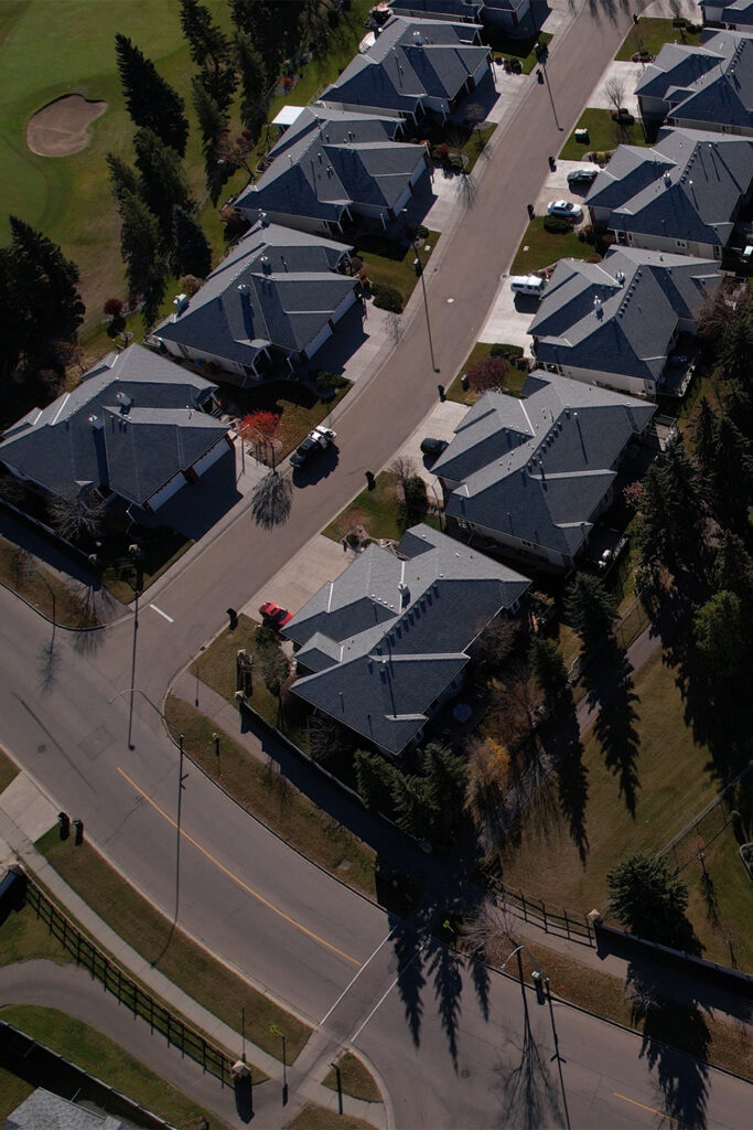 A drone shot of the Spruce Grove golf course, with large homes near by.