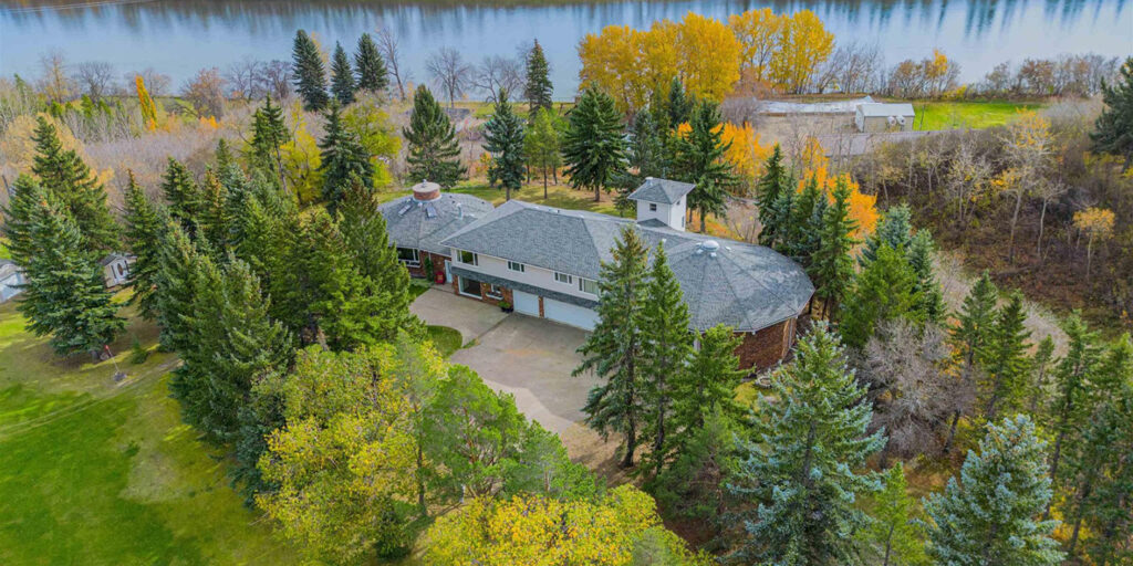 In Sturgeon County, a large home sits on an acreage beside a river.