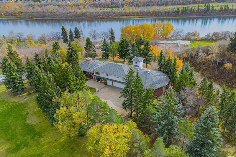 In Sturgeon County, a large home sits on an acreage beside a river.