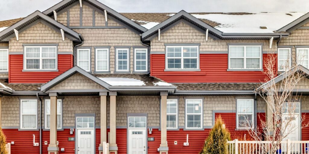 Red and brown townhouses in the Orchards at Ellerslie Edmonton neighbouhood.