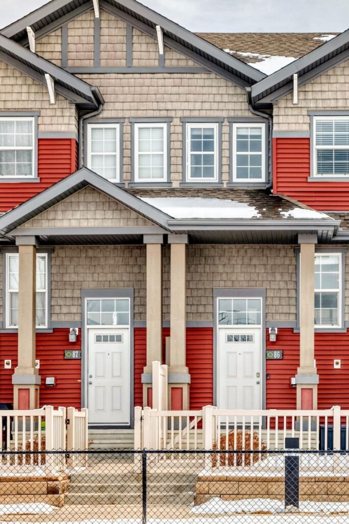 Red and brown townhouses in the Orchards at Ellerslie Edmonton neighbouhood.