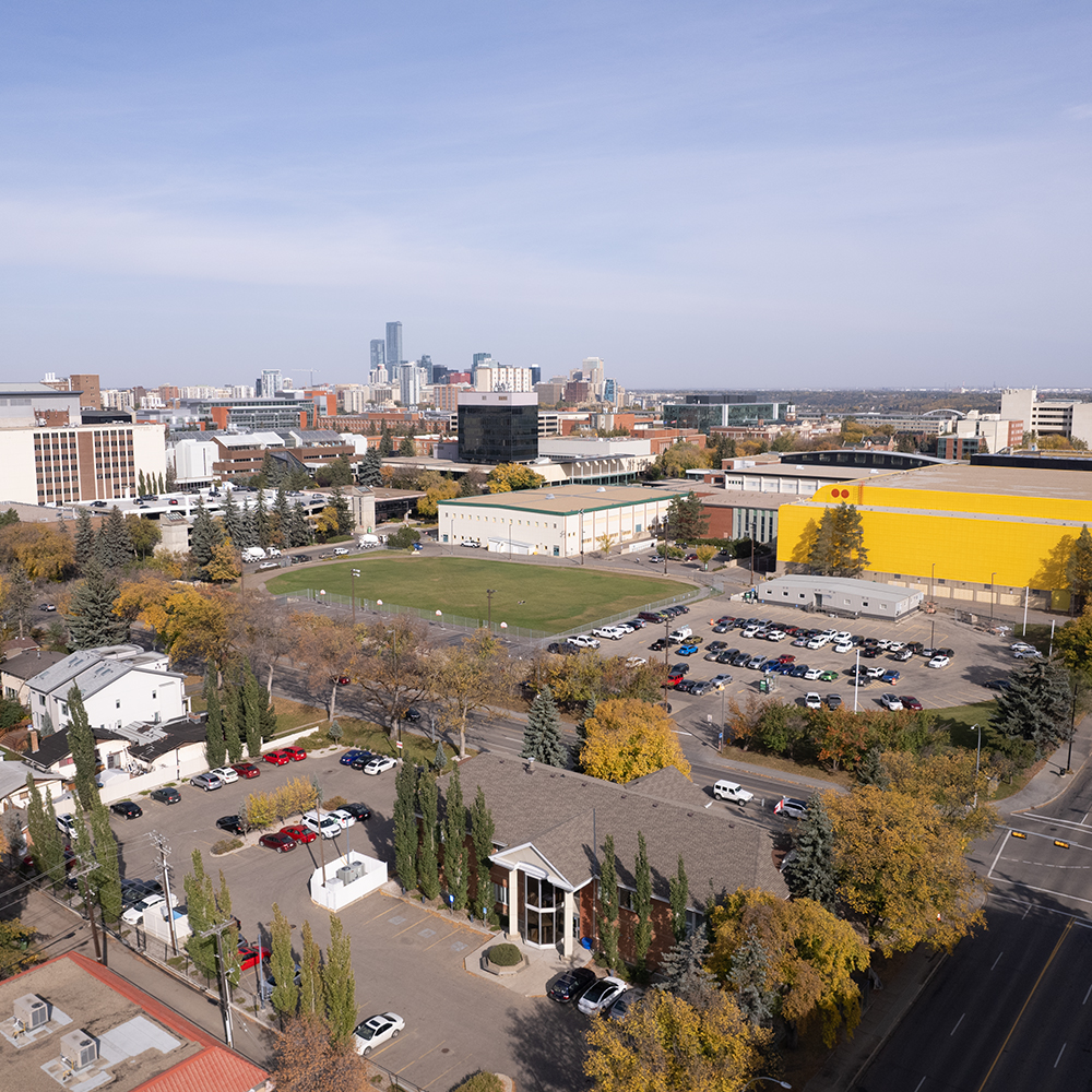 An aerial view of the University of Alberta in Edmonton. The Butterdome is bright near the centre of the image, surrounded by buildings and parking areas.