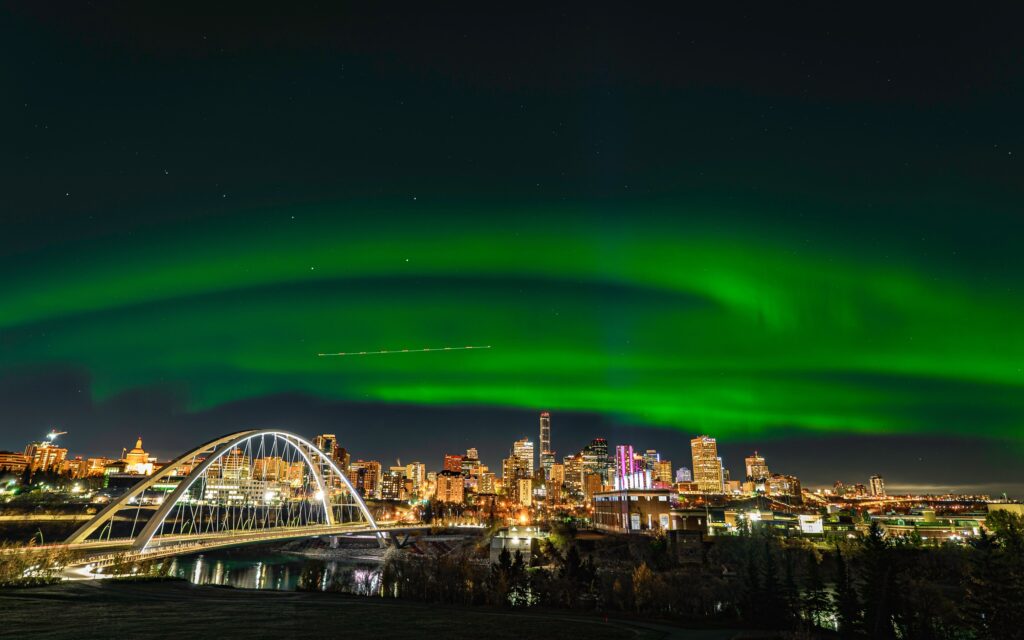 The green northern lights dance over the Edmonton skyline.