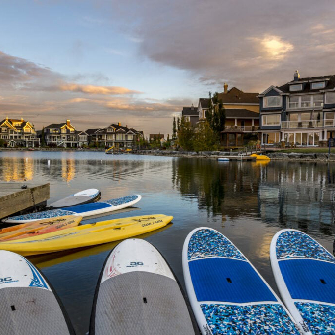 Paddleboards floating on the lake at Summerside community in south Edmonton