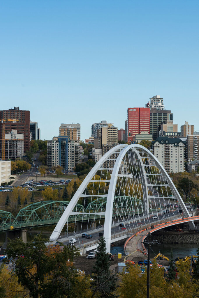 Birds eye view of Edmonton's river valley and downtown skyline. The Walterdale Bridge is in the foreground, reaching over the North Saskatchewan River.