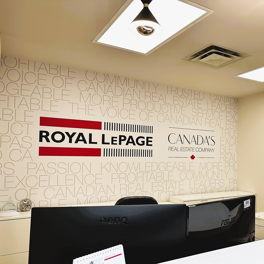 Inside shot of the Royal LePage Noralta office; words behind the desk read: 