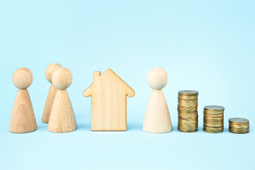 Wooden house and wooden little men on a blue background. Property division . Insurance concept, loans.