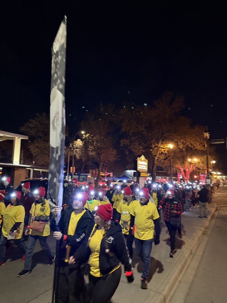 Group photo of friends, families, and supporters before the start of the Night Light Walk.