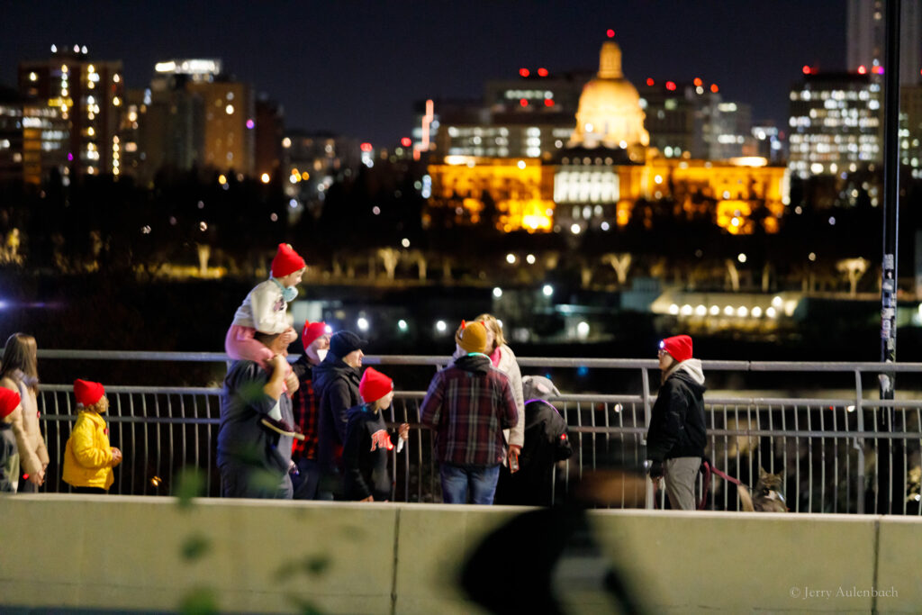 Walkers make their way along Edmonton’s scenic Saskatchewan Drive during the Royal LePage Noralta Night Light Walk, with the Legislature glowing across the river — a powerful symbol of light, hope, and community.