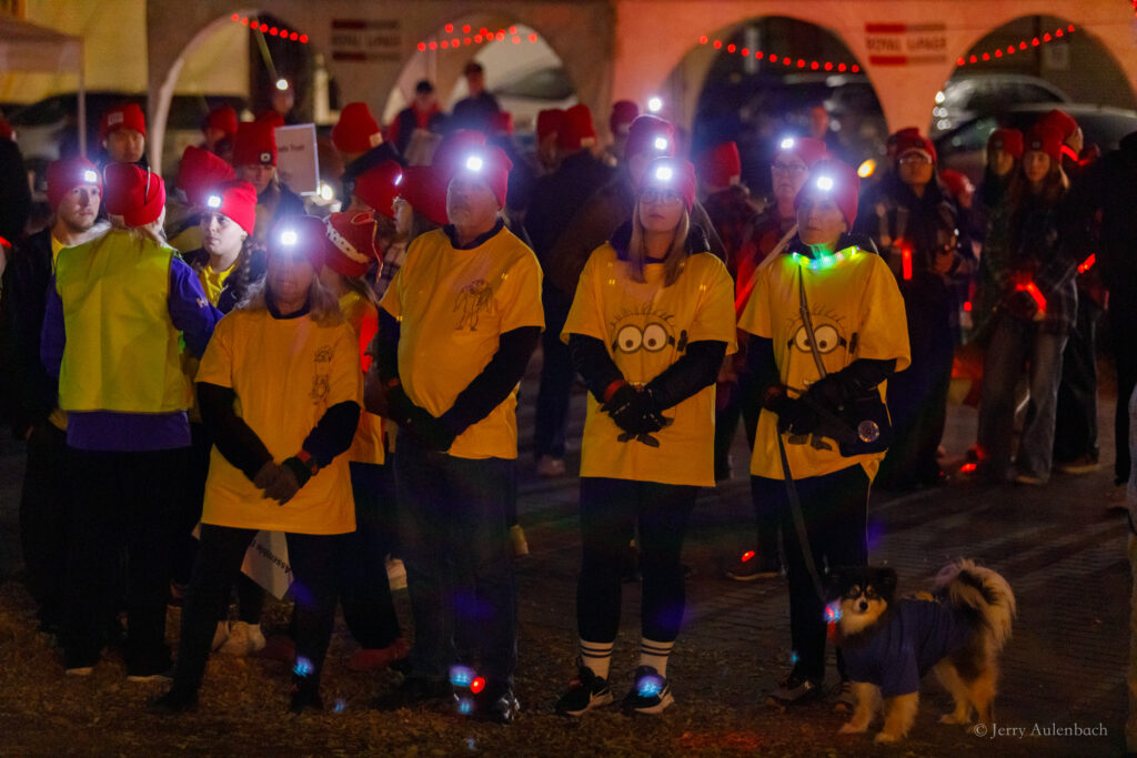 Team Minion posing with a dog dressed for the event.